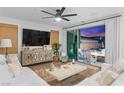 Bright living room with wood floors, contemporary decor, and sliding glass doors to the backyard at 2710 Marchetti Pl, Henderson, NV 89044