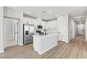 Modern kitchen featuring stainless steel appliances, white cabinets, and a large island at 3240 Lahontan St, North Las Vegas, NV 89032