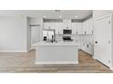 Modern kitchen featuring stainless steel appliances, white cabinets, and a large island at 3240 Lahontan St, North Las Vegas, NV 89032