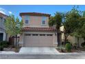 Two-story house with tile roof and a wide two-car garage door at 3311 Fico Ave, Las Vegas, NV 89141