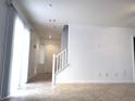 Spacious living area featuring stairway, tile flooring, and lots of natural light at 3311 Fico Ave, Las Vegas, NV 89141