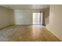 Bright living area with tiled floor and sliding glass doors to the outside at 3311 Fico Ave, Las Vegas, NV 89141