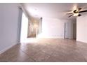 Bright living area featuring stairway, tile flooring, and door for closet space at 3311 Fico Ave, Las Vegas, NV 89141