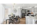 Open concept view of kitchen and dining area featuring modern lighting and stainless appliances at 3425 E Russell Rd # 202, Las Vegas, NV 89120