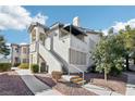 Well-maintained condo exterior with steps leading to the upper units and landscaped surroundings at 3425 E Russell Rd # 202, Las Vegas, NV 89120