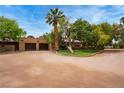 Front view of estate showing a long driveway leading to the home and garage at 3455 Five Pennies Ln, Las Vegas, NV 89120