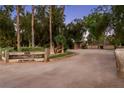 Long driveway leading to a home featuring mature trees and landscaping at 3455 Five Pennies Ln, Las Vegas, NV 89120