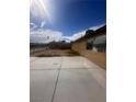 View of spacious backyard featuring concrete patio and block fencing around perimeter at 3933 Lighthouse Ave, Las Vegas, NV 89110