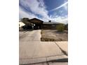 Modest single-story home featuring a covered carport and drought tolerant landscaping at 3933 Lighthouse Ave, Las Vegas, NV 89110