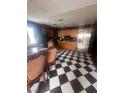 Spacious kitchen with a black and white checkerboard floor and stainless steel appliances at 3933 Lighthouse Ave, Las Vegas, NV 89110