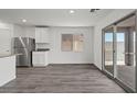 Bright dining area with stainless steel fridge and sliding glass doors leading to the outdoor space at 4223 Gold Desert St, North Las Vegas, NV 89032