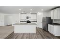 Modern kitchen with stainless steel appliances, a center island, and sleek countertops at 4223 Gold Desert St, North Las Vegas, NV 89032