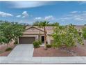 Expansive view of the well-maintained, single-story home featuring desert landscaping and an attached garage at 4317 Via Vinci Ct, Pahrump, NV 89061
