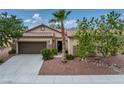 Inviting single-story home showcasing desert landscaping, a two-car garage, and a welcoming front entrance at 4317 Via Vinci Ct, Pahrump, NV 89061