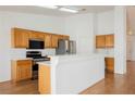 Bright kitchen with stainless steel appliances and wooden cabinets at 4412 Red Blanket Rd, North Las Vegas, NV 89032