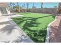 Expansive backyard with artificial turf and a concrete patio provides the perfect spot for outdoor entertaining at 4416 Inez Dr, Las Vegas, NV 89130