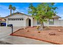 Attractive home showcasing desert landscaping, a two-car garage, and a welcoming entrance at 4430 Eureka Cir, Las Vegas, NV 89103
