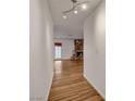 Bright hallway leading to a spacious living area with hardwood floors and a stone fireplace at 4430 Eureka Cir, Las Vegas, NV 89103