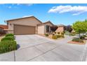 Attractive single-story home showcasing desert landscaping, expansive driveway, and an attached two car garage at 4436 Hatch Bend Ave, North Las Vegas, NV 89031