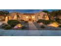 Charming single-story home featuring a desert-landscaped front yard, an arched entryway and an attached two-car garage at 4980 Pensier St, Las Vegas, NV 89135