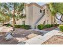 Inviting condo exterior featuring manicured bushes, tidy landscaping and a private entrance at 6480 Annie Oakley Dr # 314, Las Vegas, NV 89120