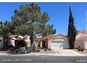 Single-story home boasts terra cotta tile roof, desert landscaping and attached two-car garage in a sunny setting at 6512 Sterling Springs Pkwy, Las Vegas, NV 89108