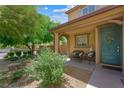 Inviting front porch with seating area, lush greenery, and a charming front door, creating a warm welcome at 6713 Guidestar St, North Las Vegas, NV 89084