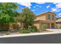 Well-maintained front yard with mature trees and shrubbery, complemented by a neutral stucco exterior at 6713 Guidestar St, North Las Vegas, NV 89084