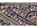 An aerial view of a community featuring homes with pools and well-maintained landscaping at 6726 Montezuma Castle Ln, North Las Vegas, NV 89084