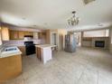 Spacious kitchen with island, tile flooring, stainless steel appliances, and a fireplace at 6726 Montezuma Castle Ln, North Las Vegas, NV 89084