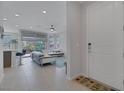 Open concept living area featuring bright white walls, neutral tiling, and a fan at 6934 Alexandrite Peak St, Las Vegas, NV 89148