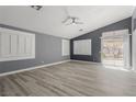 Spacious living room boasting neutral paint, modern flooring, and natural light from windows and sliding glass door at 71 Blaven Dr, Henderson, NV 89002