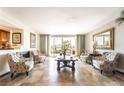 Bright living room with tile floors, balcony access, and six chairs at 750 S Royal Crest Cir # 317, Las Vegas, NV 89169