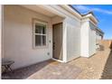 The home showcases a cozy front patio with pavers leading up to the charming front door at 8668 Marcana St, Las Vegas, NV 89166