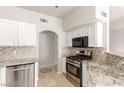 Kitchen featuring stainless steel appliances, granite countertops, tile backsplash, and white cabinets at 9000 Las Vegas Blvd # 1016, Las Vegas, NV 89123