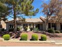 Charming single story exterior surrounded by mature trees and manicured landscaping at 9369 Villa Ridge Dr, Las Vegas, NV 89134