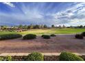 Overlook the picturesque golf course from the backyard; manicured lawns and stunning sky at 9369 Villa Ridge Dr, Las Vegas, NV 89134