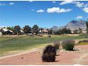 Scenic view of the golf course and mountains from the property at 9369 Villa Ridge Dr, Las Vegas, NV 89134