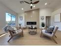 Comfortable living room with a cozy electric fireplace, modern decor, and neutral color palette at 9369 Villa Ridge Dr, Las Vegas, NV 89134