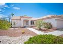 Inviting front exterior with desert landscaping, walkway, and colorful flowering bushes at 10321 Marymont Pl, Las Vegas, NV 89134