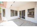 Covered patio with multiple windows and a sliding glass door offering a seamless indoor-outdoor transition at 10321 Marymont Pl, Las Vegas, NV 89134