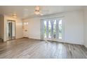 Spacious living room with light wood-look tile floors and bright glass doors to the outside at 1034 Tam O Shanter, Las Vegas, NV 89109