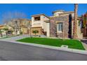 Charming two-story home featuring a three-car garage, stone accents, and low maintenance artificial grass at 10530 Eagle Nest St, Las Vegas, NV 89141
