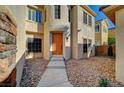 Close up of home's front door and entrance, showing desert landscaping and decorative stone accents at 10530 Eagle Nest St, Las Vegas, NV 89141