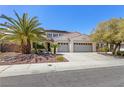 Exterior of a home showing a well-manicured front yard and a three-car garage at 11550 Velicata Ct, Las Vegas, NV 89138