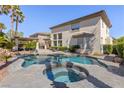 Backyard showcasing a custom pool, hot tub, and patio area with seating at 11550 Velicata Ct, Las Vegas, NV 89138