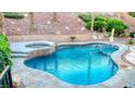 Backyard swimming pool and hot tub featuring flagstone coping and mature landscaping at 11550 Velicata Ct, Las Vegas, NV 89138