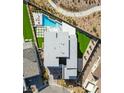 Modern home showcasing a pristine geometric pool, lush landscaping, and sleek rooftop design, capturing upscale outdoor living at 11943 Rockview Point St, Las Vegas, NV 89138