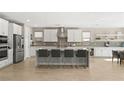 Bright, expansive kitchen with white cabinetry, a large center island with seating, and stainless steel appliances at 11943 Rockview Point St, Las Vegas, NV 89138