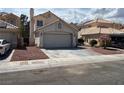 Charming single-story home with a two-car garage, front rock landscaping, and tile roof at 1249 Lucia Dr, Las Vegas, NV 89128